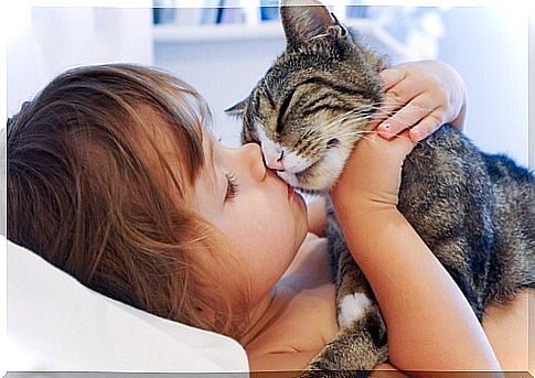 girl kissing a cat