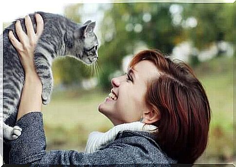 woman smiling at her cat