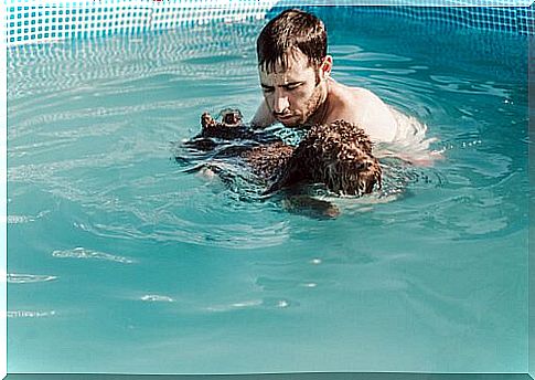 owner with dog in the pool