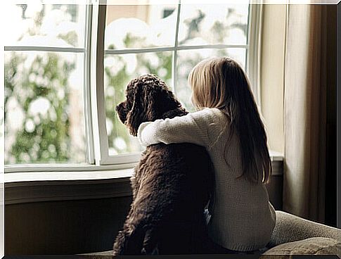 girl hugging a dog