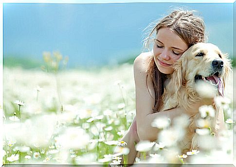 girl hugging a labrador